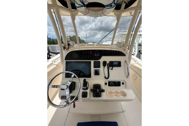 Slide: The Image of 2017 Grady-White Canyon 306 helm with steering wheel and navigation controls. - 3