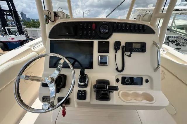 Slide: The Image of Control panel of 2017 Grady-White Canyon 306 boat with steering wheel and navigation equipment. - 4