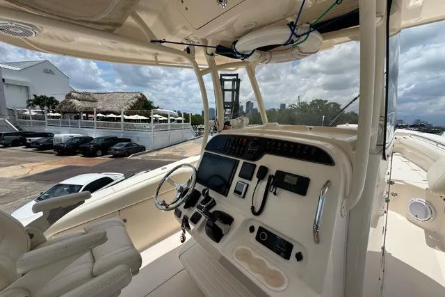 Slide: The Image of 2017 Grady-White Canyon 306 boat helm with modern controls and steering wheel. - 5