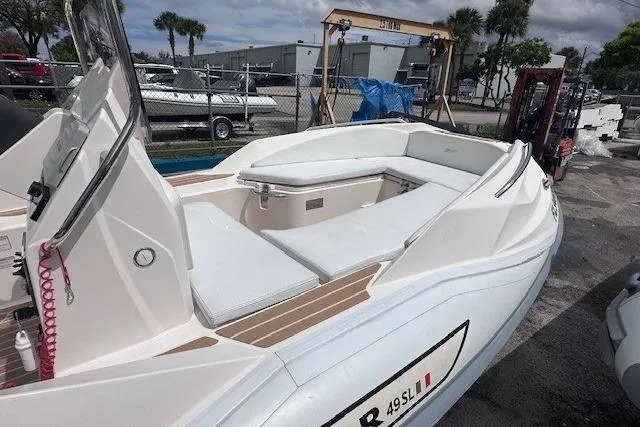 Slide: The Image of 2017 Zar Formenti 49 SL boat with white seating, docked outdoors. - 5