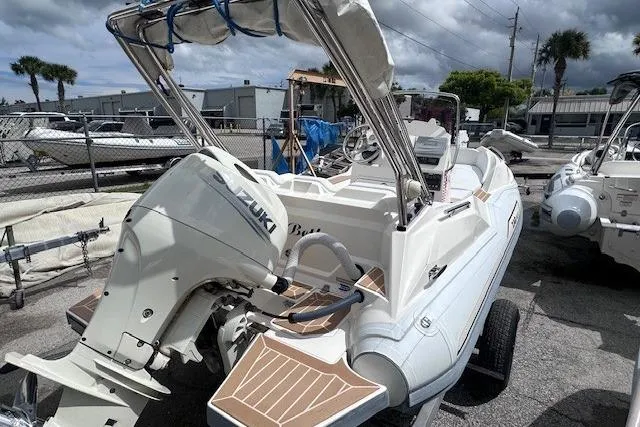 Slide: The Image of 2017 Zar Formenti 49 SL boat with Suzuki outboard motor, parked in a marina. - 6