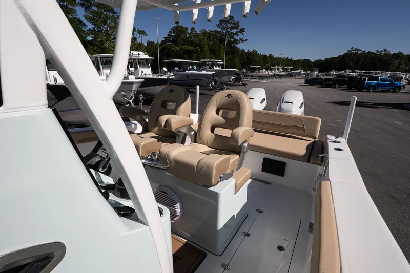 Slide: The Image of 2026 Sea Pro 265FLX Sandbar boat interior with beige seating and modern controls. - 12