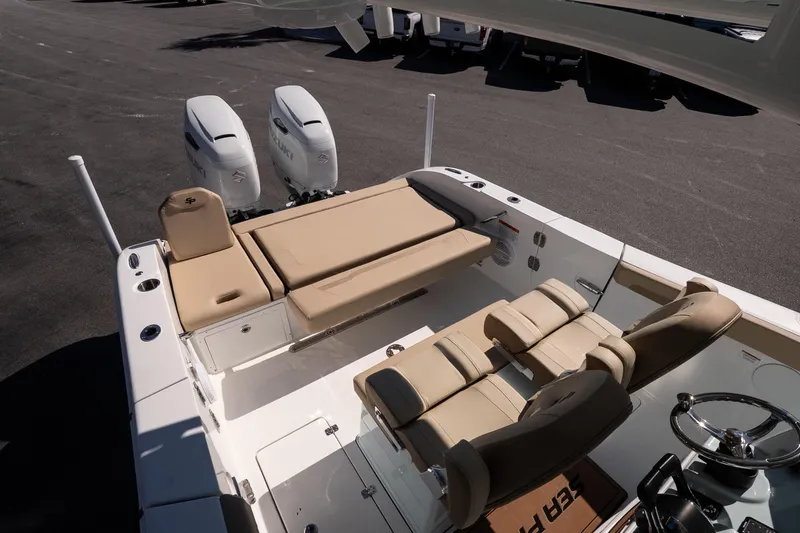 Slide: The Image of 2026 Sea Pro 265FLX Sandbar boat interior with dual engines and beige seating. - 14