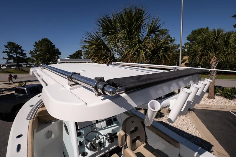 Slide: The Image of 2026 Sea Pro 265FLX Sandbar boat with rod holders and sleek design under palm trees. - 20
