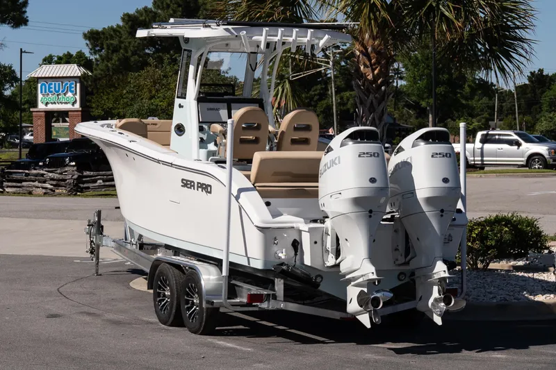 Slide: The Image of 2026 Sea Pro 265FLX Sandbar boat on trailer, featuring dual Suzuki 250 engines. - 4