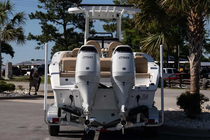 Slide: The Image of 2026 Sea Pro 265FLX Sandbar boat with dual 250 horsepower engines, parked outdoors. - 5