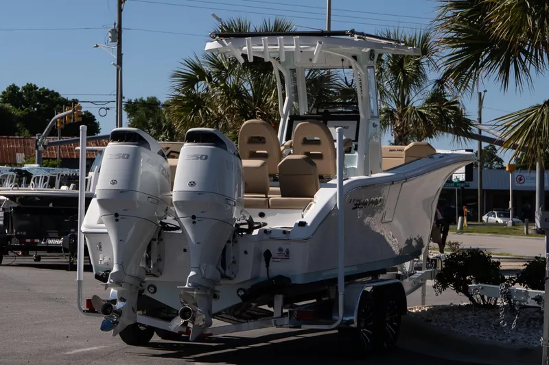 Slide: The Image of 2026 Sea Pro 265FLX Sandbar boat with dual engines, parked outdoors. - 6