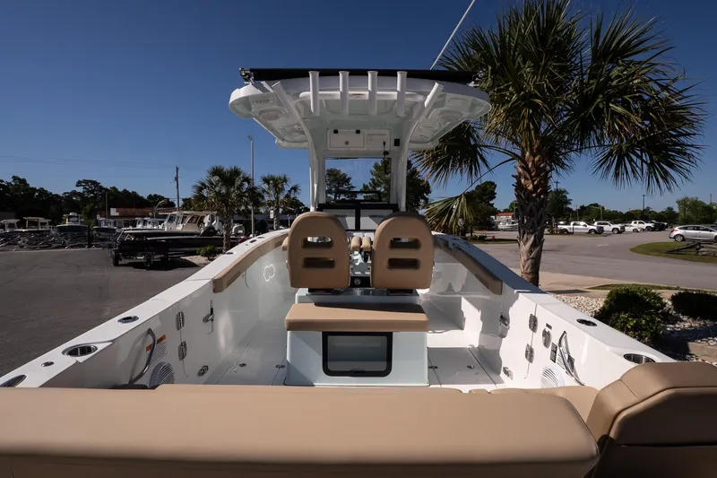 Slide: The Image of 2026 Sea Pro 265FLX Sandbar boat with dual seats, palm trees in background. - 7