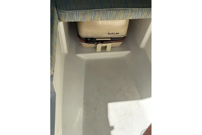 Slide: The Image of Interior of 1989 Pursuit 2260 Denali boat with storage compartment and cooler. - 12