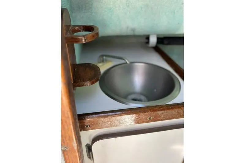 Slide: The Image of 1989 Pursuit 2260 Denali boat interior with stainless steel sink and wooden accents. - 13