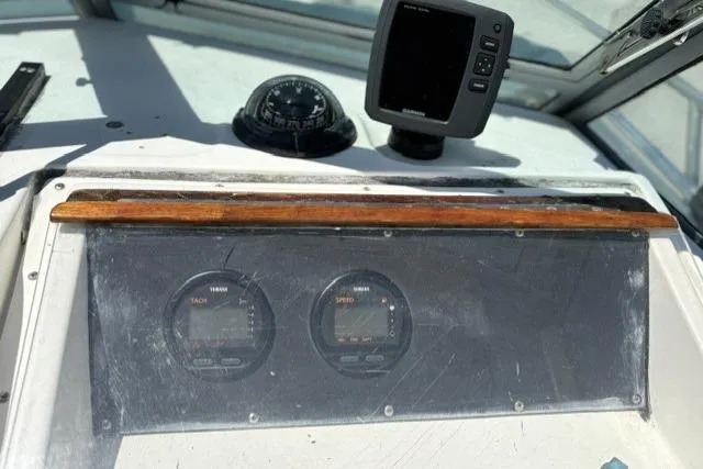 Slide: The Image of Dashboard of a 1989 Pursuit 2260 Denali boat with gauges and navigation equipment. - 16