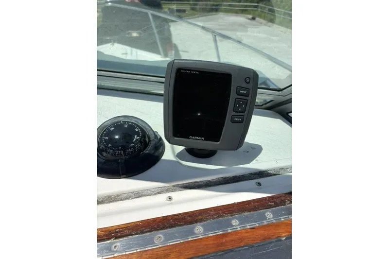 Slide: The Image of Garmin Echo 551c fishfinder and compass on 1989 Pursuit 2260 Denali boat dashboard. - 17
