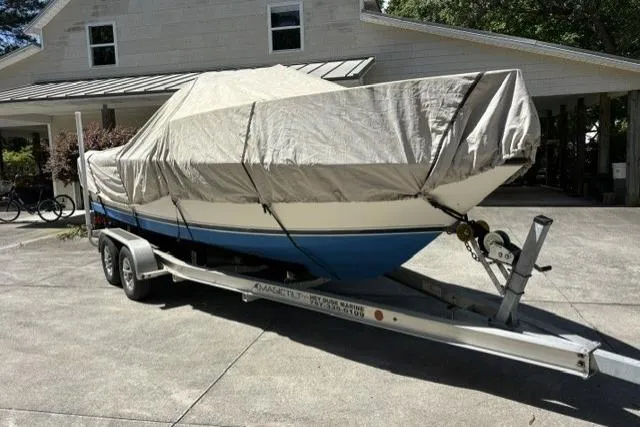 Slide: The Image of Covered 1989 Pursuit 2260 Denali boat on trailer, parked in driveway. - 29
