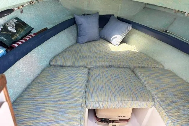 Slide: The Image of Cozy cabin interior of 1989 Pursuit 2260 Denali boat with cushions and pillows. - 7