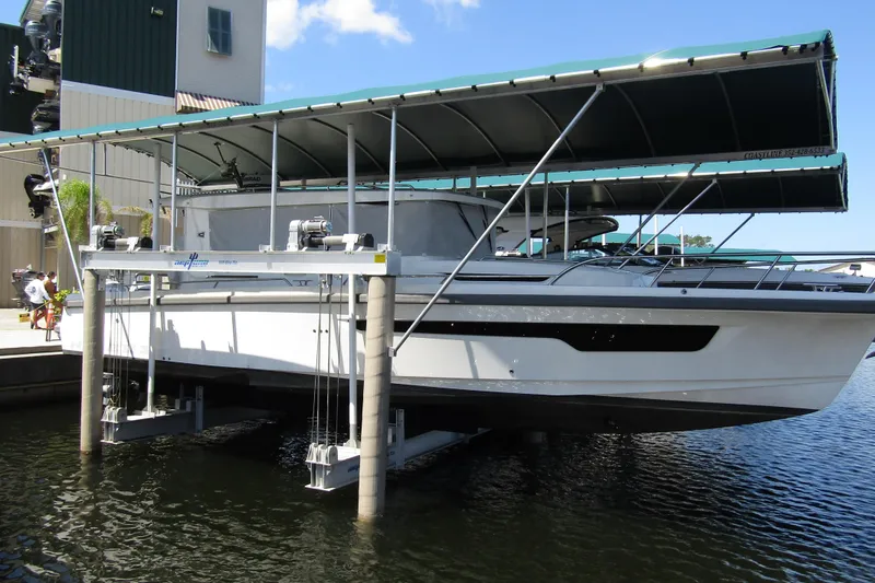 The Image of 2024 Nimbus Commuter 11 boat on lift under canopy at marina. - 0