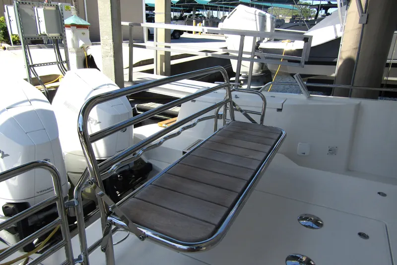 Slide: The Image of 2024 Nimbus Commuter 11 boat with dual Mercury engines and sleek deck seating. - 10
