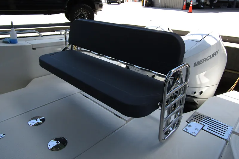 Slide: The Image of 2024 Nimbus Commuter 11 boat seat with Mercury engine in background. - 11