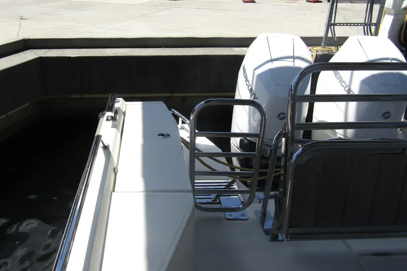 Slide: The Image of 2024 Nimbus Commuter 11 boat with dual Mercury outboard engines at dockside. - 14