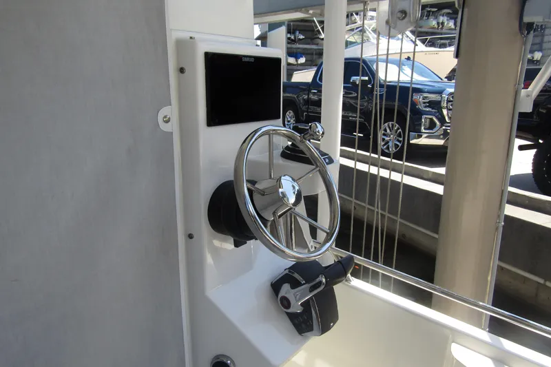 Slide: The Image of Steering console of 2024 Nimbus Commuter 11 boat, featuring a sleek wheel and control panel. - 18