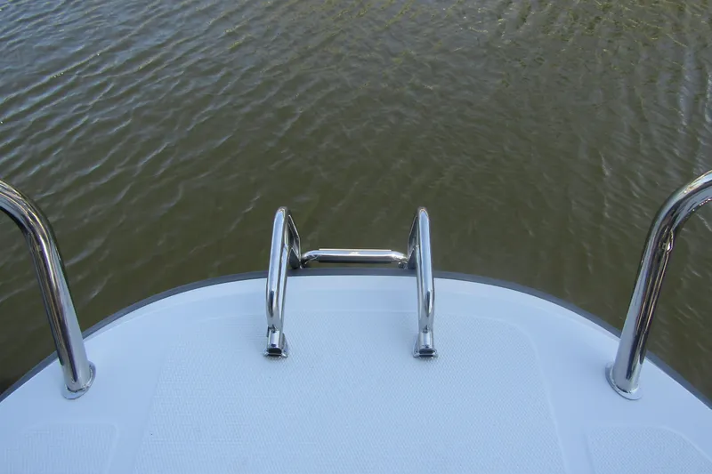 Slide: The Image of 2024 Nimbus Commuter 11 boat deck with stainless steel railing over water. - 23