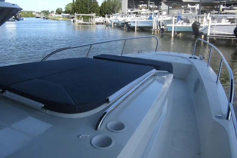 Slide: The Image of 2024 Nimbus Commuter 11 boat docked, featuring sleek design and spacious deck area. - 27