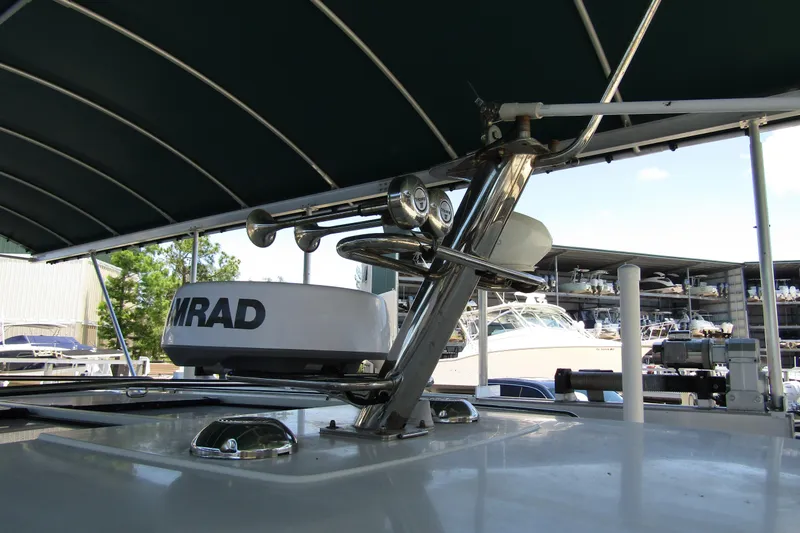 Slide: The Image of Radar equipment on 2024 Nimbus Commuter 11 boat, under canopy, with marina background. - 28