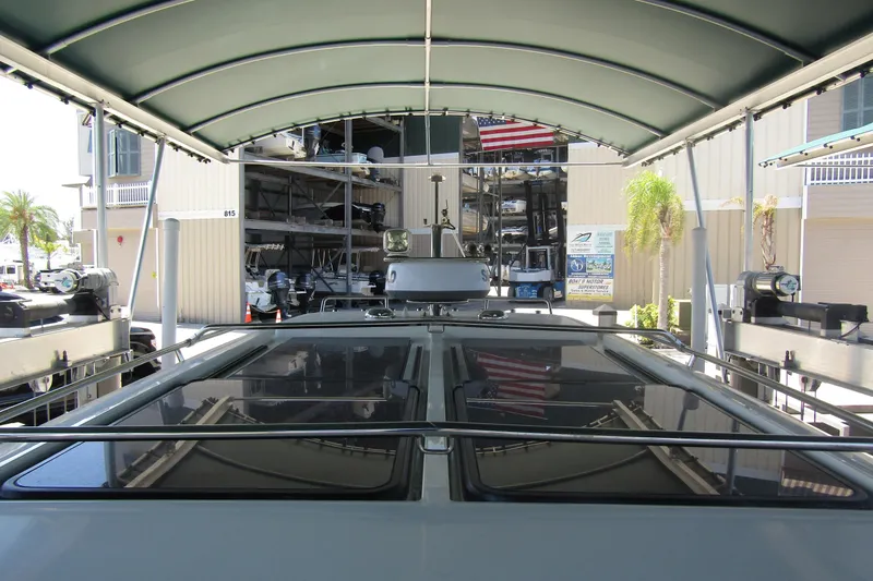 Slide: The Image of 2024 Nimbus Commuter 11 boat under canopy at marina storage facility. - 29