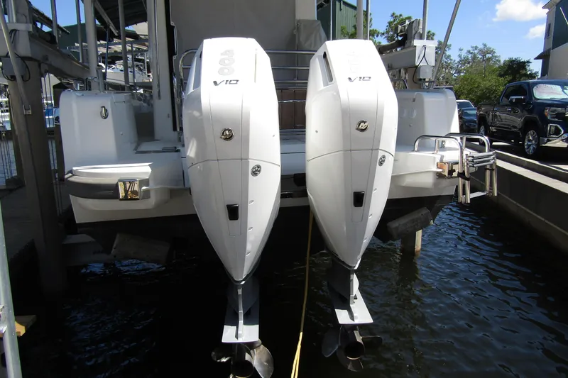 Slide: The Image of 2024 Nimbus Commuter 11 with dual V10 outboard engines docked at marina. - 3