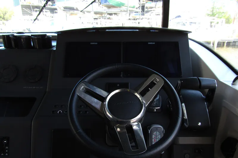 Slide: The Image of Steering wheel and dashboard of 2024 Nimbus Commuter 11 boat. - 32