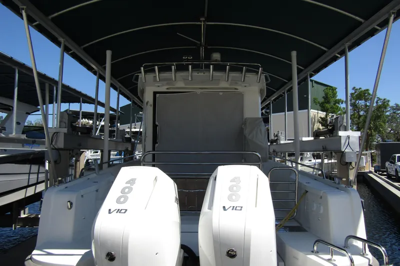 Slide: The Image of 2024 Nimbus Commuter 11 boat with dual 400 V10 engines, docked under a canopy. - 4