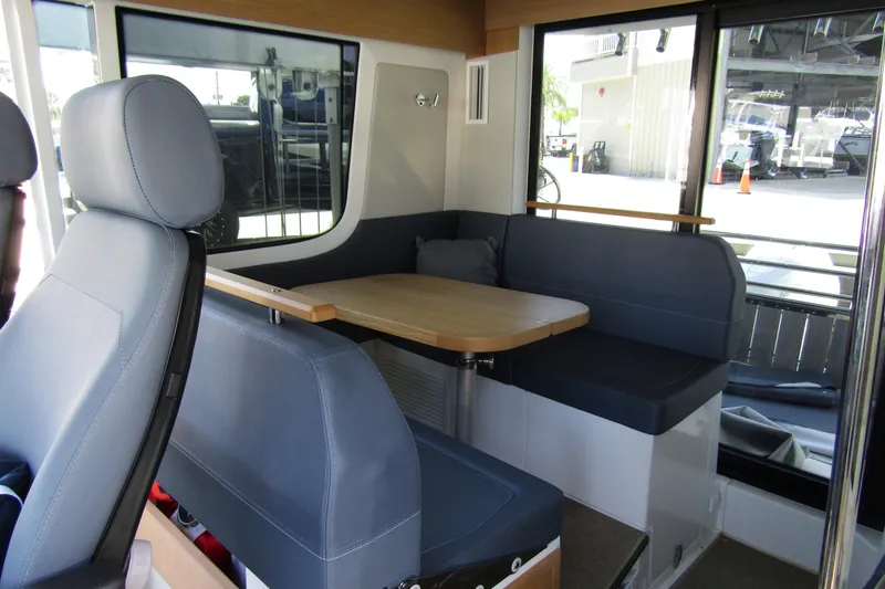 Slide: The Image of Interior of 2024 Nimbus Commuter 11, featuring a cozy seating area with a wooden table. - 44