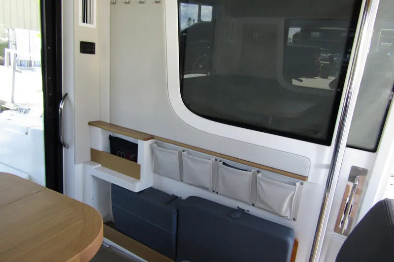 Slide: The Image of 2024 Nimbus Commuter 11 interior with modern storage and seating design. - 45