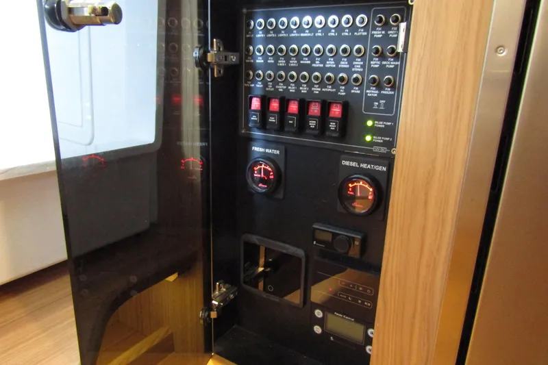 Slide: The Image of Electrical control panel inside 2024 Nimbus Commuter 11, featuring gauges and switches. - 48