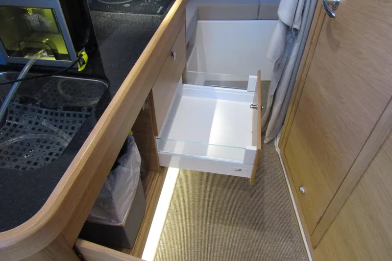 Slide: The Image of 2024 Nimbus Commuter 11 interior kitchen with open drawer and modern design. - 54