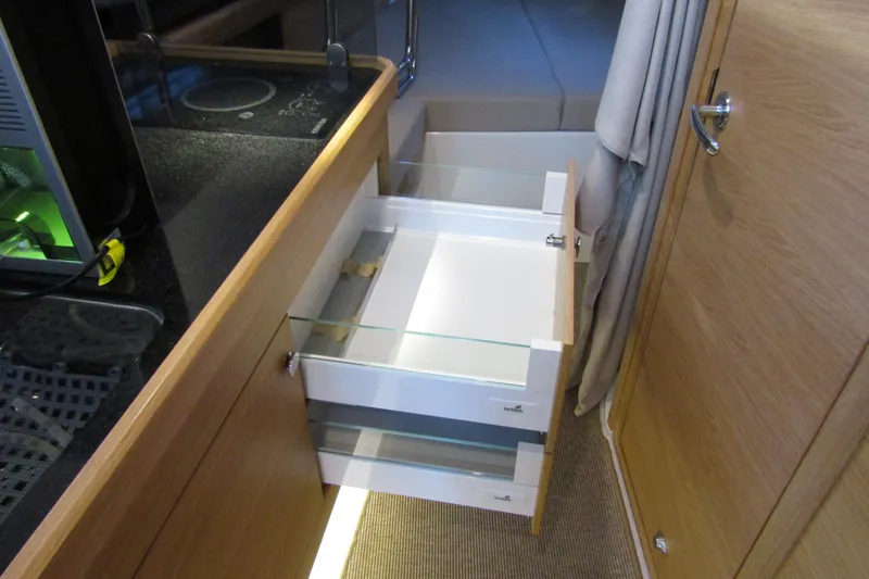 Slide: The Image of Interior of 2024 Nimbus Commuter 11 with open storage drawers and sleek design. - 55