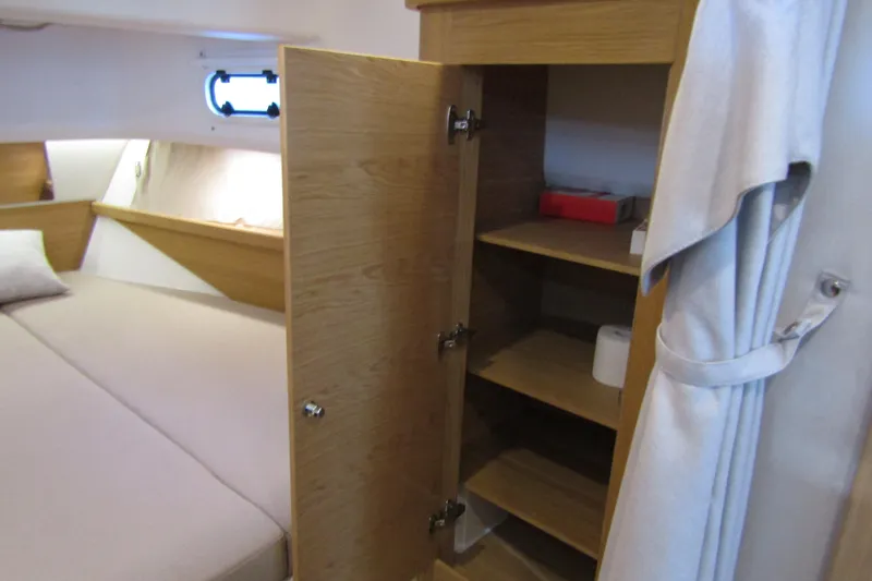 Slide: The Image of 2024 Nimbus Commuter 11 cabin interior with open wooden storage cabinet. - 57