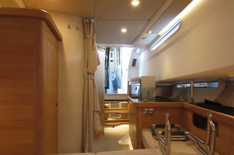 Slide: The Image of Interior of 2024 Nimbus Commuter 11 boat, featuring modern wood finishes and sleek design. - 58