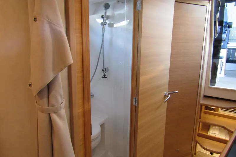 Slide: The Image of 2024 Nimbus Commuter 11 interior bathroom with wooden door and shower. - 59