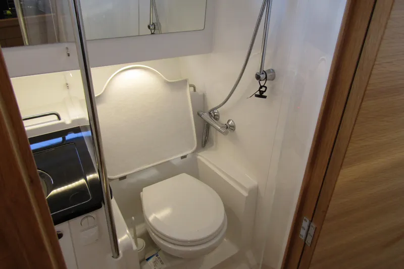 Slide: The Image of Compact bathroom in 2024 Nimbus Commuter 11 boat, featuring toilet and shower. - 61