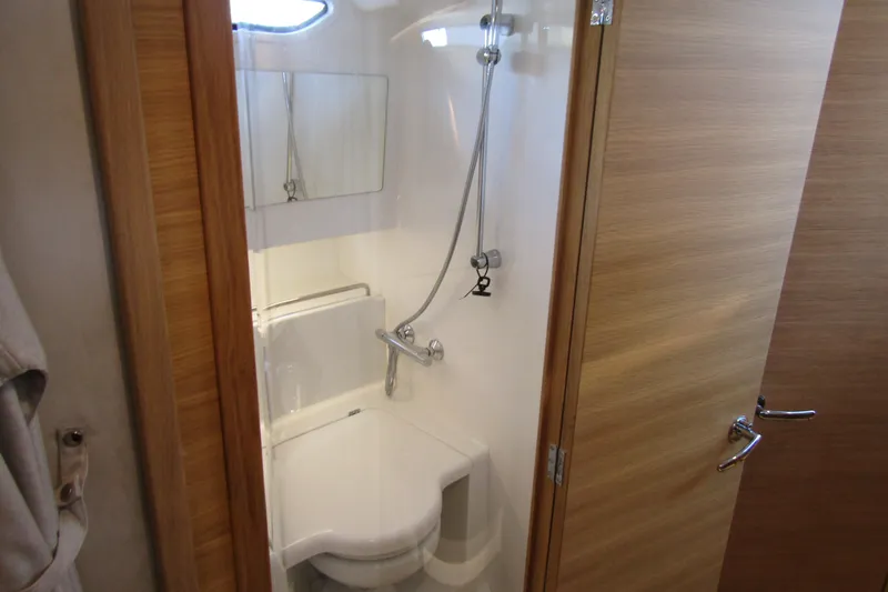 Slide: The Image of Compact bathroom in 2024 Nimbus Commuter 11, featuring a shower and toilet. - 63