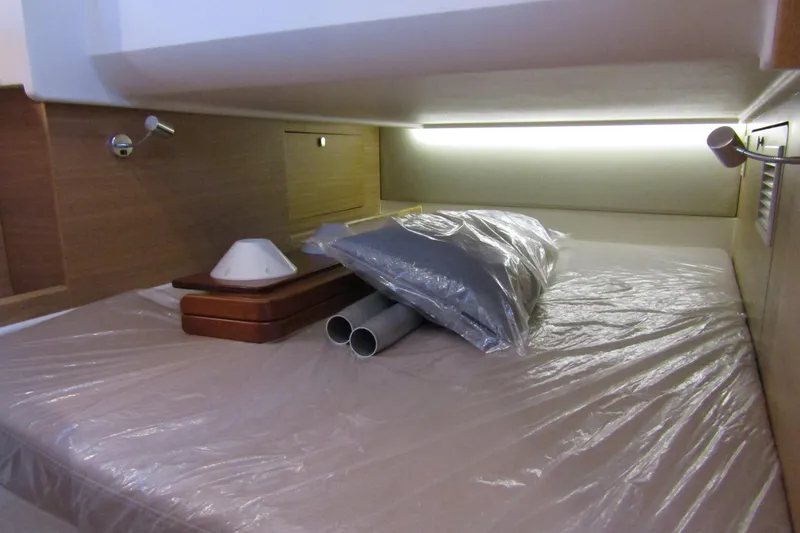 Slide: The Image of 2024 Nimbus Commuter 11 cabin interior with bed, pillows, and ambient lighting. - 65