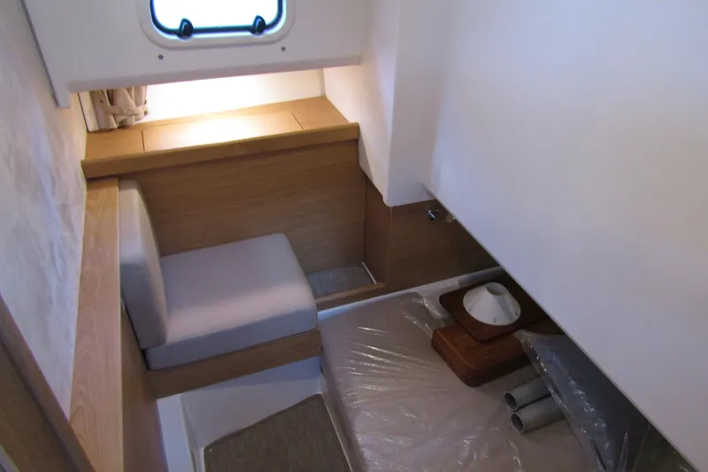 Slide: The Image of 2024 Nimbus Commuter 11 cabin interior with wooden accents and seating area. - 66