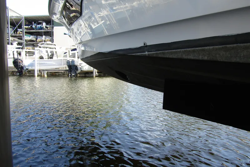 Slide: The Image of 2024 Nimbus Commuter 11 boat docked, showcasing sleek hull design and marina setting. - 7