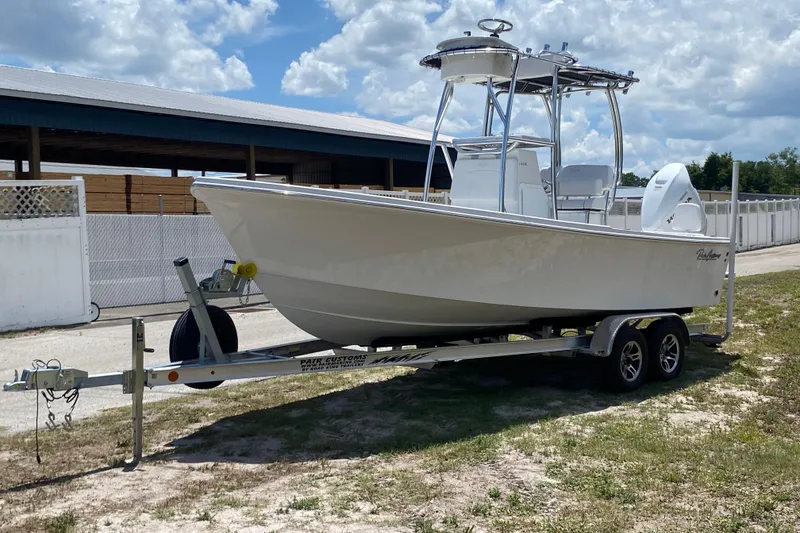 The Image of 2026 Pair Customs 21 Center Console MV boat on trailer under cloudy sky. - 0