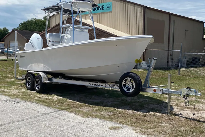 Slide: The Image of 2026 Pair Customs 21 Center Console MV boat on trailer, parked outdoors. - 1