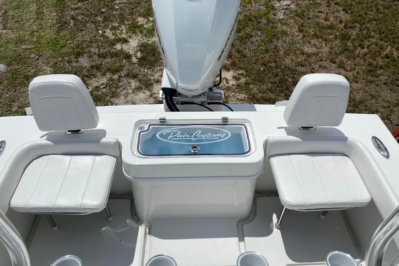Slide: The Image of 2026 Pair Customs 21 Center Console MV boat interior with white seating and branded compartment. - 14