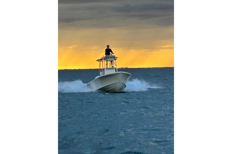 Slide: The Image of 2026 Pair Customs 21 Center Console MV boat cruising at sunset on open water. - 16