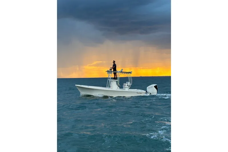 Slide: The Image of 2026 Pair Customs 21 Center Console MV boat cruising at sunset on open water. - 17