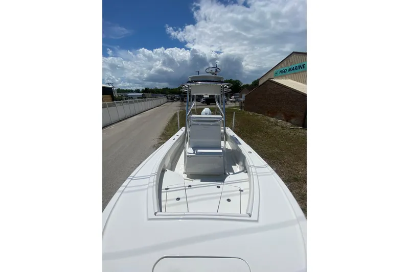 Slide: The Image of 2026 Pair Customs 21 Center Console MV boat at dockside under cloudy sky. - 2
