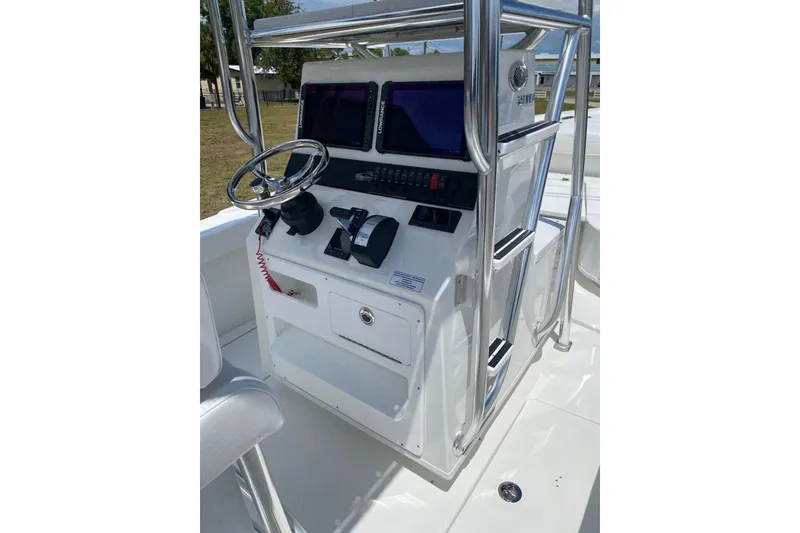 Slide: The Image of 2026 Pair Customs 21 Center Console MV boat dashboard with steering wheel and controls. - 5